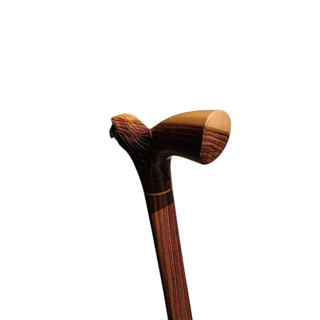 The derby grip seen from behind, with the pale palm rest ahead of the carved head