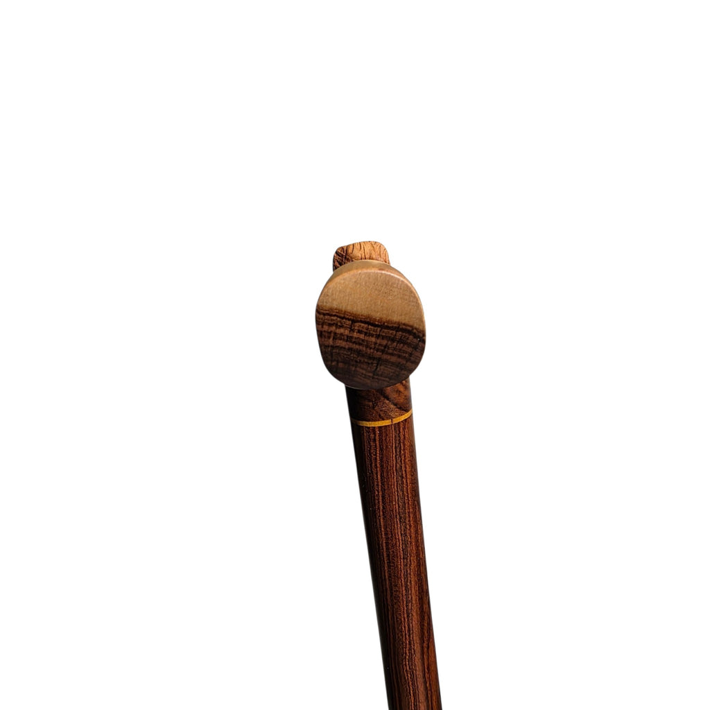 Back of the handle, showing the rounded palm rest in pale laurel above the shaft
