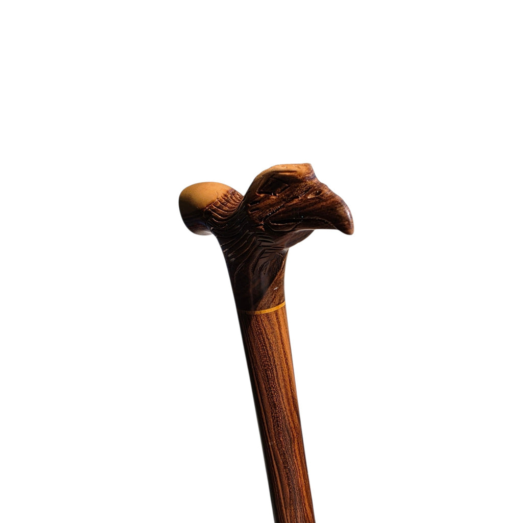 The carved eagle head at the front of the handle, seen from the front of the cane