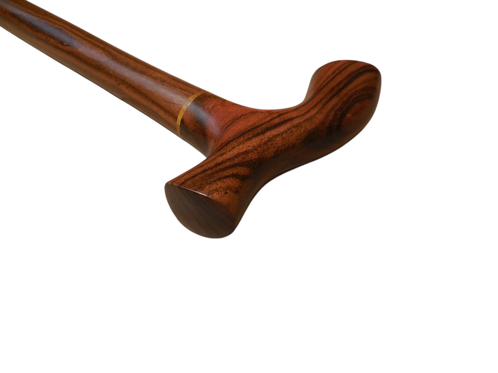 Tikal cane handle seen from the front, with dark flame figuring running down the laurel shaft