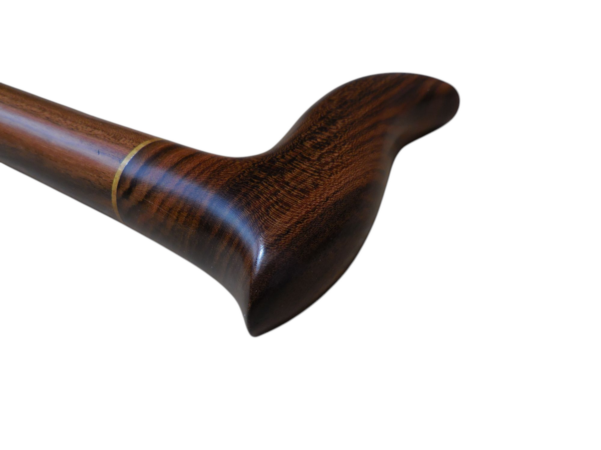 Sendero walking cane handle angled to show the sweep of the grip and the wood figure