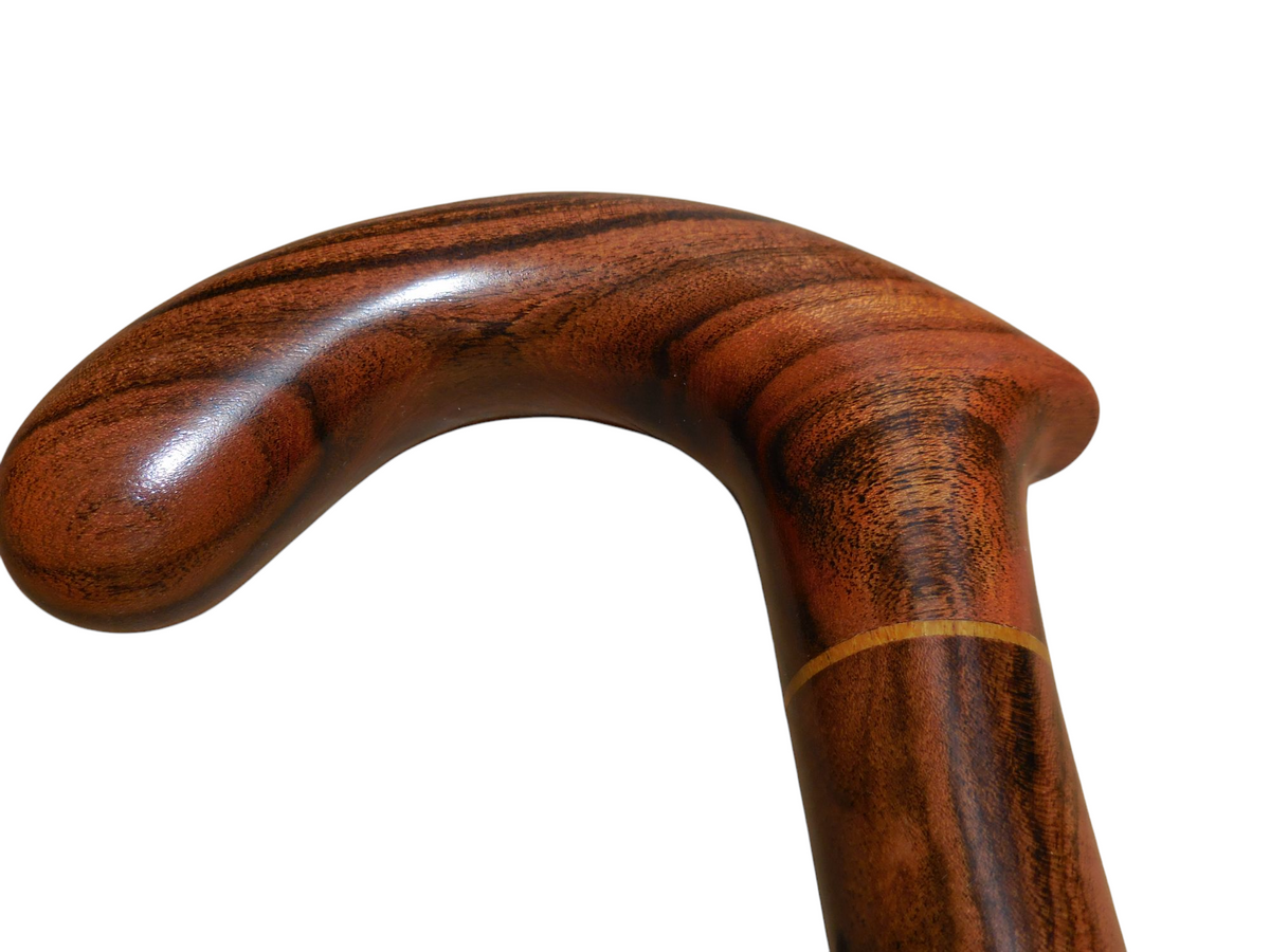Xibalba cane handle from the front, with the paler laurel band where the handle meets the shaft