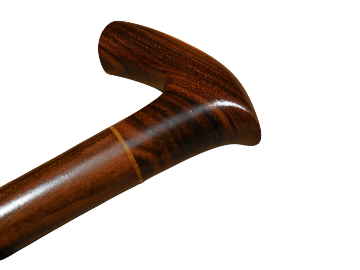 Sombra cane handle from behind, with the laurel shaft running down to the right