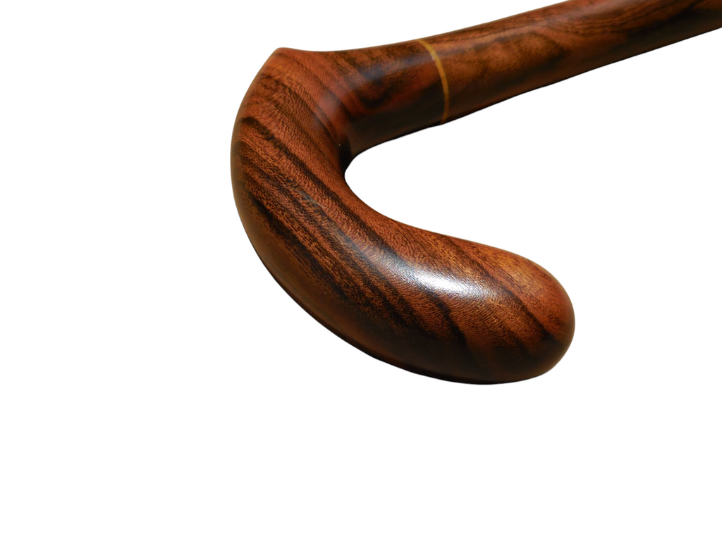 Xibalba cane handle turned to show the depth of the curve and the figure in the laurel