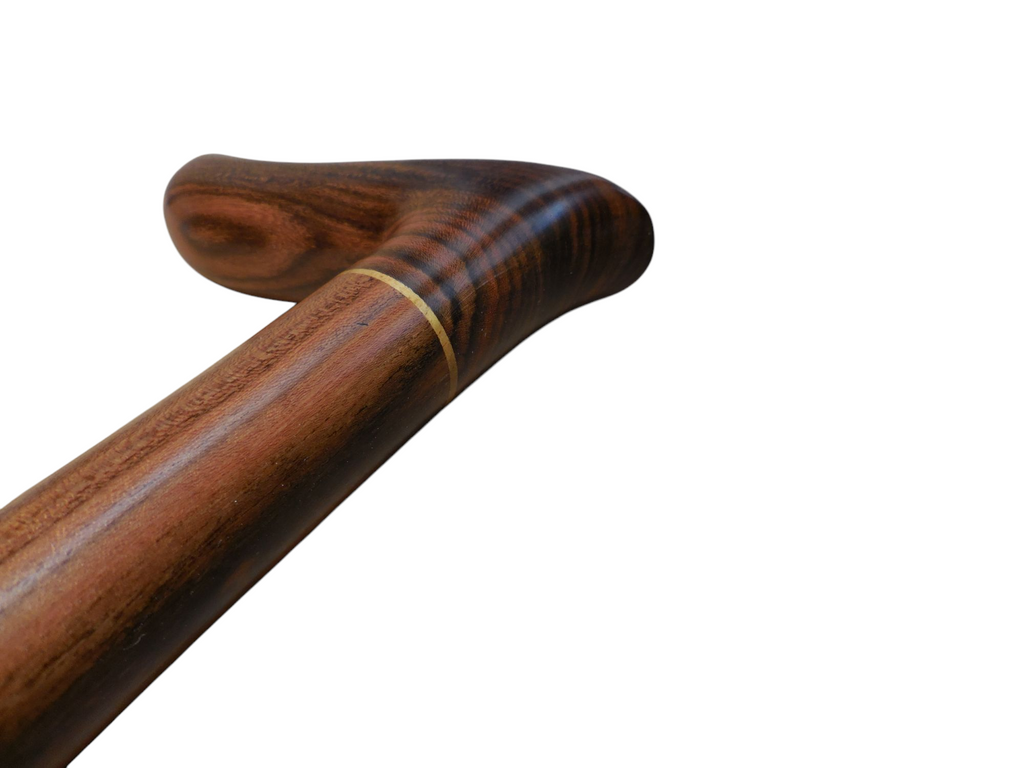 Sendero cane handle at an angle with the polished laurel shaft below